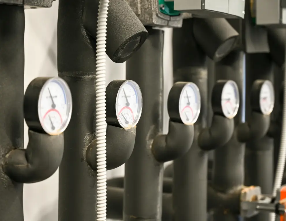 A row of pipes with different gauges on them.