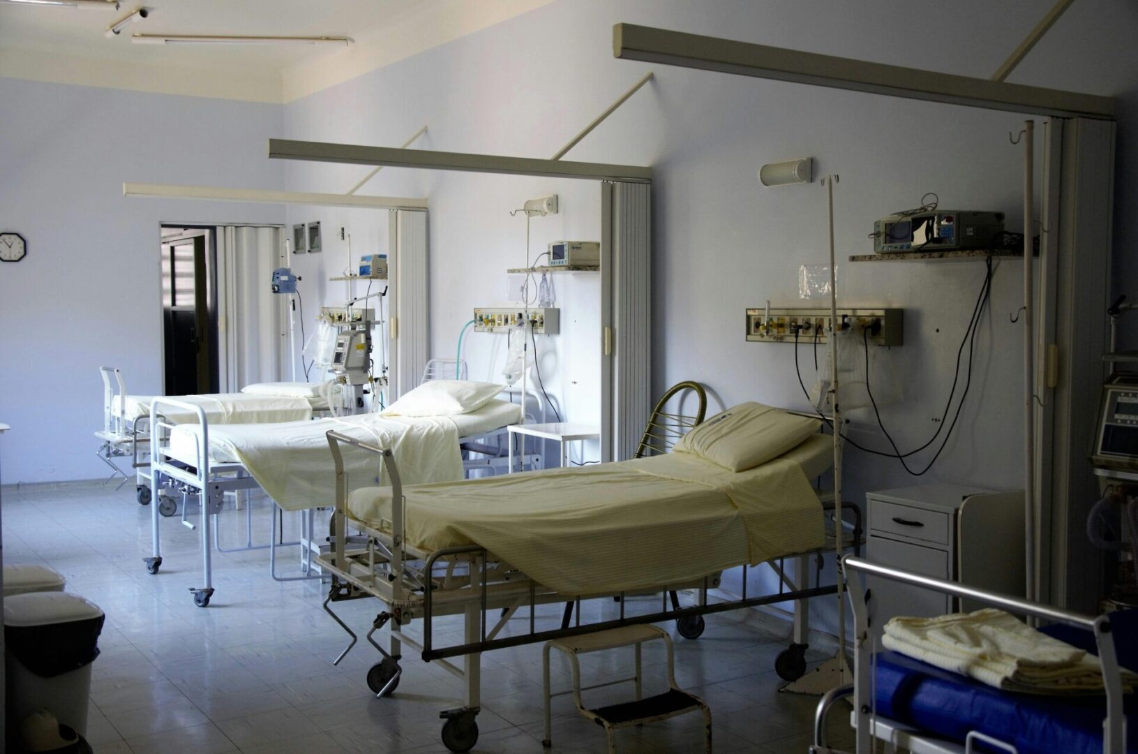 Empty hospital room with several beds.