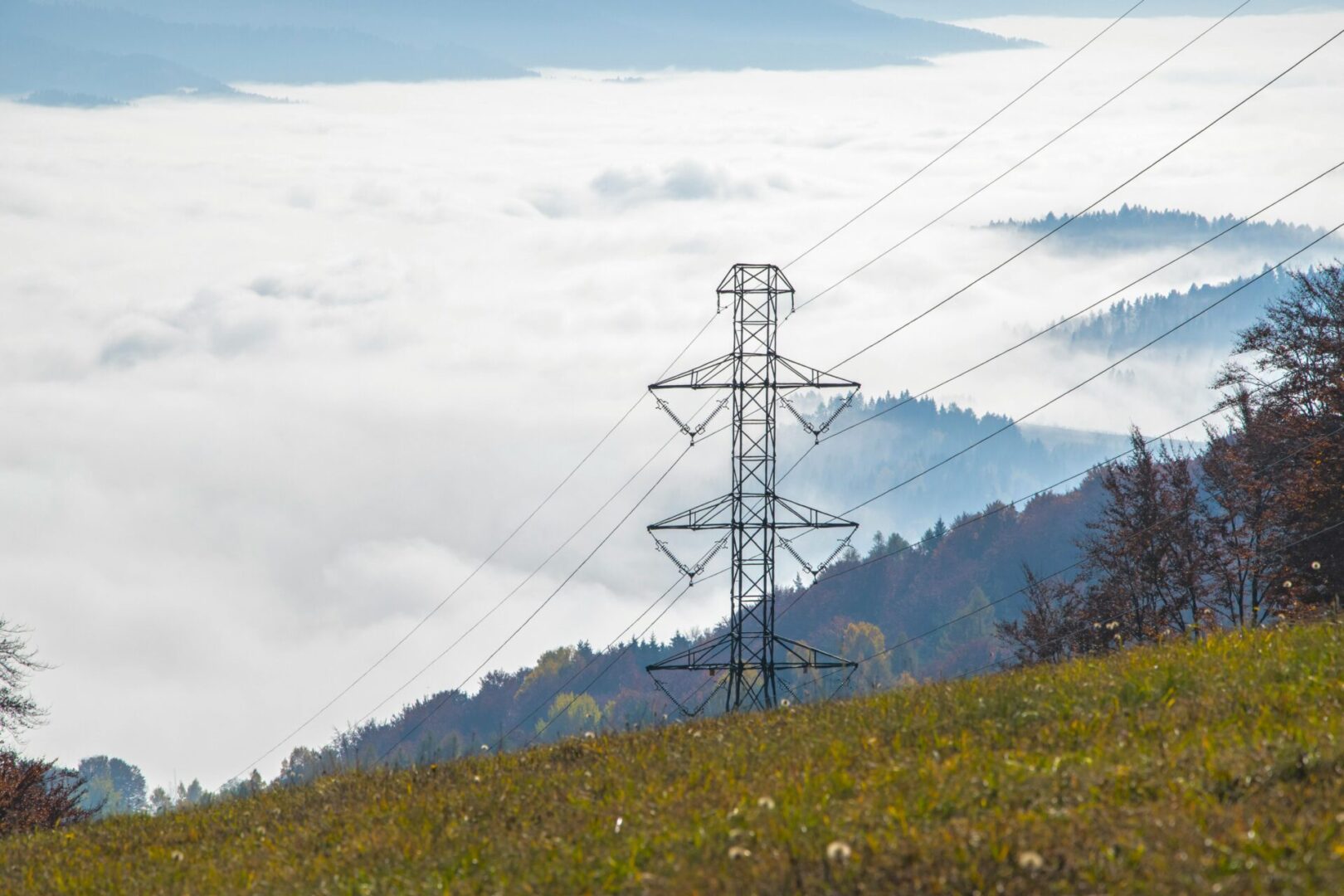 Power lines above a foggy landscape.